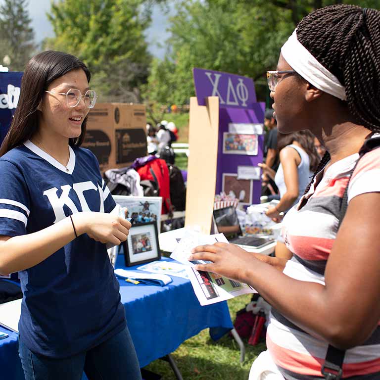 students talking to each other at an outdoor event