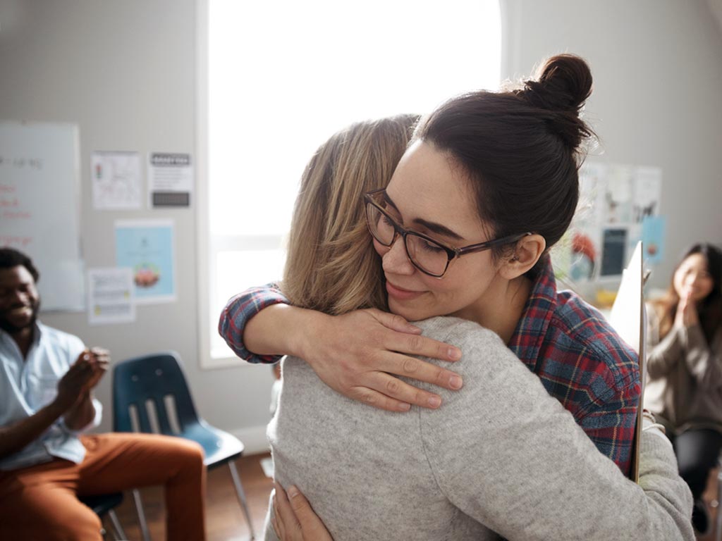 two women hugging each other